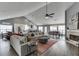 Open-concept living room with a fireplace, vaulted ceilings, and seamless access to the kitchen and dining area at 802 Towering Pine Trl, Lawrenceville, GA 30045