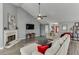 Open living area with a fireplace, ample seating, and seamless flow to other living spaces at 802 Towering Pine Trl, Lawrenceville, GA 30045