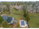 Expansive estate featuring a pool, basketball court, and a sprawling lawn leading to a large brick home at 1483 Jones Rd, Roswell, GA 30075