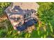 Aerial view of home, deck, and the lush backyard showcasing mature trees and landscaping at 1483 Jones Rd, Roswell, GA 30075