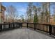 Spacious wooden deck with black railings, perfect for outdoor living and entertaining at 1483 Jones Rd, Roswell, GA 30075