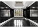 Formal dining room with black walls, black hardwood floors, and a modern chandelier at 1483 Jones Rd, Roswell, GA 30075
