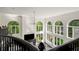 Bright foyer with large windows, dark floors, and black railings overlooking main level at 1483 Jones Rd, Roswell, GA 30075