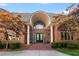Grand brick home entrance featuring stately columns and an arched doorway at 1483 Jones Rd, Roswell, GA 30075