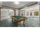 Spacious game room featuring a billiard table and large windows providing ample natural light at 1483 Jones Rd, Roswell, GA 30075