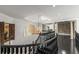 Upstairs hallway with staircase and railing, arched window, chandelier, and stone columns at 1483 Jones Rd, Roswell, GA 30075