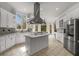 Gourmet kitchen with stainless steel appliances, island cooktop and white cabinetry at 1483 Jones Rd, Roswell, GA 30075