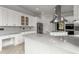 Bright kitchen with stainless appliances, marble counters and white cabinets at 1483 Jones Rd, Roswell, GA 30075
