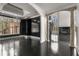Open-concept living room featuring black hardwood floors, a spiral staircase, and multiple windows at 1483 Jones Rd, Roswell, GA 30075
