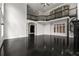 Open-concept living room featuring a spiral staircase, fireplace, and balcony overlooking the main floor at 1483 Jones Rd, Roswell, GA 30075