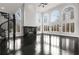 Open living room featuring hardwood floors, spiral staircase, fireplace, and large arched windows at 1483 Jones Rd, Roswell, GA 30075
