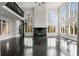 Open living room featuring hardwood floors, spiral staircase, fireplace, and large arched windows at 1483 Jones Rd, Roswell, GA 30075