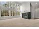 Spacious living room with fireplace and wall of bright, two-story windows at 1483 Jones Rd, Roswell, GA 30075