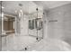 Modern bathroom featuring a glass shower, updated vanities with dual sinks, and marble floors at 1483 Jones Rd, Roswell, GA 30075