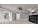 Spacious main bedroom featuring a ceiling fan, fireplace, tray ceiling, and ensuite bathroom at 1483 Jones Rd, Roswell, GA 30075