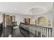 Upstairs landing with black railing and chandelier at 1483 Jones Rd, Roswell, GA 30075