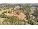 Aerial view of the property, featuring a spacious lot, mature trees, and the house nestled within the landscape at 9095 Cedar Grove Rd, Fairburn, GA 30213