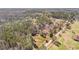 Expansive aerial view showcasing a large wooded property with a winding road, offering privacy and seclusion at 9095 Cedar Grove Rd, Fairburn, GA 30213