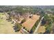 Vast acreage featuring a mix of wooded areas and open fields, bisected by a paved road, with mature trees on property lines at 9095 Cedar Grove Rd, Fairburn, GA 30213