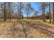 Expansive backyard with mature trees shading the home, offering a tranquil setting with natural beauty at 9095 Cedar Grove Rd, Fairburn, GA 30213