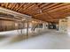 Unfinished basement with concrete floor, stone walls, and metal support beams at 9095 Cedar Grove Rd, Fairburn, GA 30213