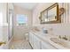 Bathroom with striped wallpaper, mosaic tile floor, and white cabinets with marble countertop at 9095 Cedar Grove Rd, Fairburn, GA 30213