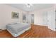Spacious bedroom featuring hardwood floors, ceiling fan, and natural light from a window at 9095 Cedar Grove Rd, Fairburn, GA 30213
