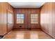 Bedroom features wood paneling, hardwood floors, and natural light at 9095 Cedar Grove Rd, Fairburn, GA 30213