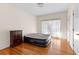 Bedroom features hardwood floors, neutral walls, and a closet at 9095 Cedar Grove Rd, Fairburn, GA 30213