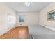 Bedroom featuring hardwood floors, a ceiling fan, and ample natural light from a window at 9095 Cedar Grove Rd, Fairburn, GA 30213