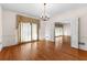 Bright dining room featuring hardwood floors, crown molding, and chandelier at 9095 Cedar Grove Rd, Fairburn, GA 30213