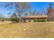 Exterior front view of ranch style house with large front yard and mature shade trees at 9095 Cedar Grove Rd, Fairburn, GA 30213