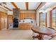 Bright eat-in kitchen featuring custom wood cabinets, brick accents, and backyard views at 9095 Cedar Grove Rd, Fairburn, GA 30213