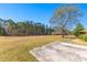 Spacious yard with large tree and view of back patio at 9095 Cedar Grove Rd, Fairburn, GA 30213