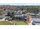 Aerial view showcasing community amenities, including a golf course, swimming pool, and tennis courts at 942 Fairfield Dr, Marietta, GA 30068