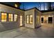 Covered back patio with an outdoor fireplace, fan, and black framed windows that open to the kitchen at 942 Fairfield Dr, Marietta, GA 30068