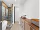 Contemporary bathroom features a glass-enclosed shower and wood vanity with vessel sinks at 942 Fairfield Dr, Marietta, GA 30068