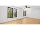 Light-filled bedroom with hardwood floors and lots of natural light coming through black frame windows at 942 Fairfield Dr, Marietta, GA 30068