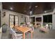 An outdoor living area with comfortable seating, a dining table, and a cozy fireplace at 942 Fairfield Dr, Marietta, GA 30068