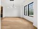Bright dining room featuring hardwood floors, modern light fixture, and large windows at 942 Fairfield Dr, Marietta, GA 30068