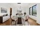 Virtually staged dining room featuring a glass table and seating for eight, with modern decor at 942 Fairfield Dr, Marietta, GA 30068