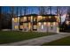Beautiful two-story home featuring a long driveway, brick facade, manicured lawn, and dark trim at 942 Fairfield Dr, Marietta, GA 30068