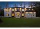 Elegant two-story home featuring a lush lawn, brick facade, dark trim, and inviting entryway at 942 Fairfield Dr, Marietta, GA 30068