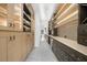 The hallway has custom cabinetry, display shelves, stainless steel wine coolers, and modern lighting at 942 Fairfield Dr, Marietta, GA 30068