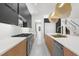 Spacious kitchen features an island with sink, stainless steel appliances, gas range, and elegant lighting at 942 Fairfield Dr, Marietta, GA 30068
