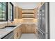U-shaped kitchen with stainless steel appliances, light wood cabinets, under cabinet lighting, and a sink under the window at 942 Fairfield Dr, Marietta, GA 30068