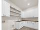 Laundry room with white shaker cabinets, butcher block countertops, open shelving, and a utility sink at 942 Fairfield Dr, Marietta, GA 30068
