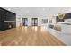 Open concept living room with hardwood floors, fireplace, and modern kitchen island at 942 Fairfield Dr, Marietta, GA 30068