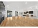Expansive living room with wood floors leading into a modern kitchen featuring an island and sleek cabinetry at 942 Fairfield Dr, Marietta, GA 30068
