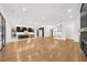 Open concept living area showcasing hardwood floors, modern kitchen, and staircase at 942 Fairfield Dr, Marietta, GA 30068